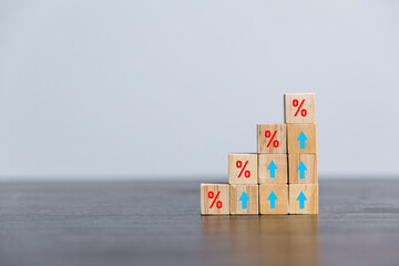Closeup wood cubes with percentage symbol, Percent and upwards increasing arrows on wooden cubes....