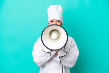 Young caucasian chef woman isolated on blue background shouting through a megaphone