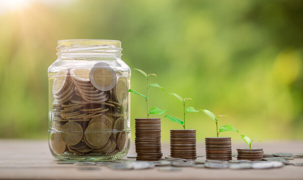 Money coin stack growing graph with glass jar saving concept. business finance and saving money investment, plant growing up on coin. Balance savings and investment. save retirement for interest idea