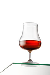 Isolated glass of whiskey, rum or brandy. copy space
