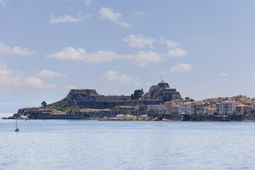 Fototapeta premium Legendary two-leveled Old Fortress of Corfu Island with twin bastions of pentagonal shape and embankment of the main port Kerkira, Greece, bright summer day