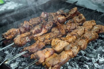 Cooking kebabs on skewers, closeup photo
