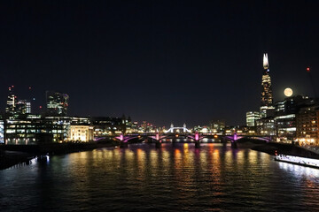 Fototapeta na wymiar View of night London at full moon, Thames, Tower Bridge and Cheesegrater building