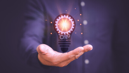Man touching a bright light bulb icon. Ideas for presenting new ideas, inspiration in the work and innovation new beginning.