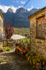 view of traditional architecture with stone buildings and background astraka mountain during fall...