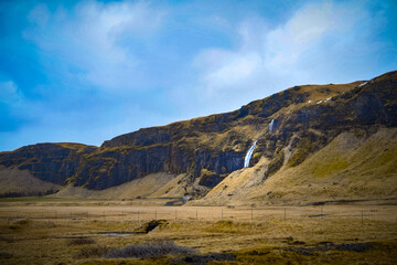 Fototapeta na wymiar Landscape with mountains and waterfall in Iceland