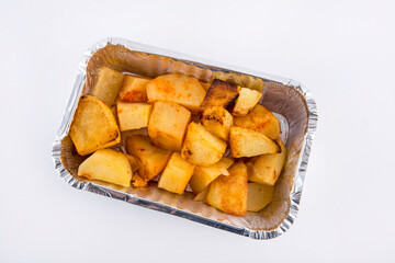 Baked potatoes served in aluminium tray