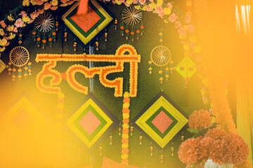 Indian wedding haldi decoration for groom and bride in yellow color