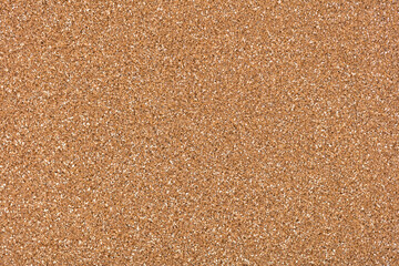 Light glitter background in new golden tone, texture for shiny design look. Elegant texture for Christmas design. Holiday abstract glitter with blinking lights. Christmas, Xmas pattern wallpaper.