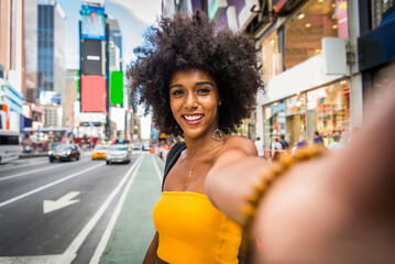 Beautiful afro-american woman walking in New York - Young black female adult tourist in Manhattan,...