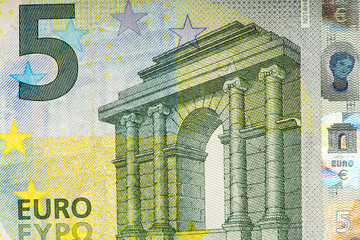 fragment of five Euro bill. 5 euro banknote close-up. The euro is the official currency of 19 out...