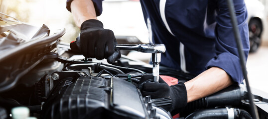 Automobile mechanic repairman hands repairing a car engine automotive workshop with a wrench, car service and maintenance , Repair service