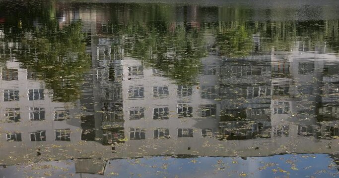 Reflection of the house in the water surface of the pond.