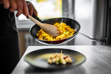 scrambled eggs with bacon in frying pan