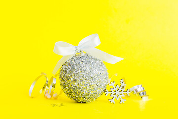 Christmas ball on colored background. decoration bauble with ribbon bow with copy space