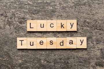 lucky Tuesday word written on wood block. lucky Tuesday text on cement table for your desing, concept