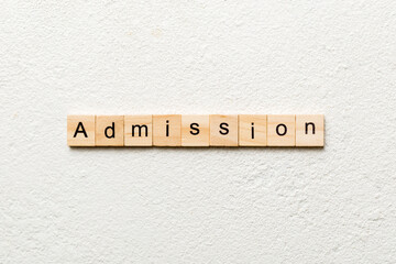 ADMISSION word written on wood block. ADMISSION text on cement table for your desing, concept