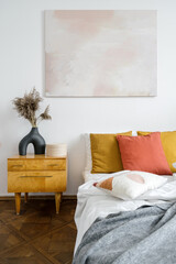 Bedroom interior with abstract painting on wall
