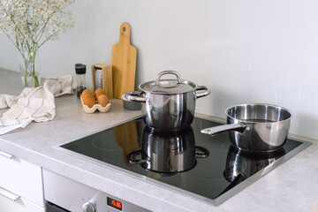 Fototapeta na wymiar cooking pot and saucepan on electric stove at modern kitchen
