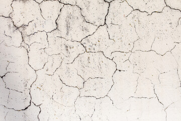 Cracked plaster on the wall of the house.