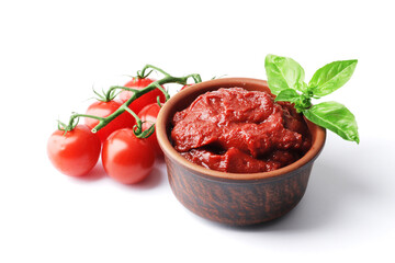 Ripe fresh tomatoes on a white plate, tomato sauce. Cooking ingredient. Fragrant spice green basil. For design.bowl with tomato sauce basil and fresh tomatoes isolated on white background.