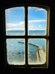 Harbor and sea view through lighthouse's window