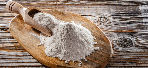 Wheat flour on the wooden cutting board