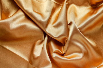 Golden shiny fabric - abstract background.