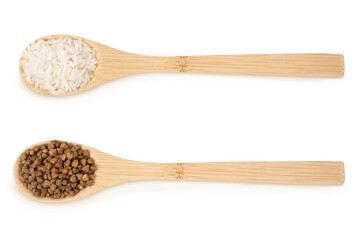 Buckwheat and rice on an isolated white background. Buckwheat and rice in wooden spoons