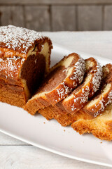 A sliced coconut cake on a plate.