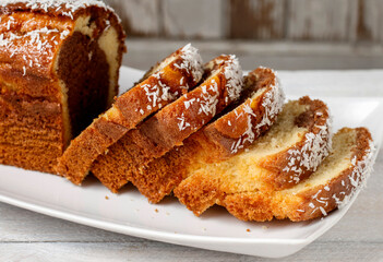 A sliced coconut cake on a plate.