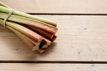 A raw rhubarb on wooden table.