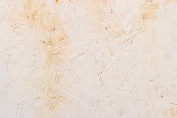 Sheet of white plywood with fragments of compressed sawdust.