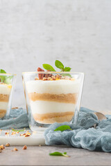 Natas do Ceu is a traditional Portuguese dessert made with cream, eggs and biscuits decorated with pecan nuts and mint leaves