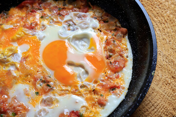 Traditional homemade scrambled eggs with ham.