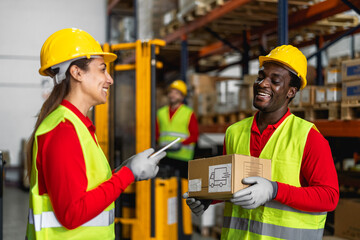 Happy multiracial people working inside logistic warehouse