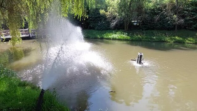 Rustic artesian fountain near a lake in nature