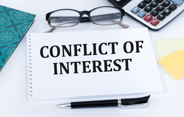 CONFLICT OF INTEREST text written on sticky on chart with keyboard and magnifier
