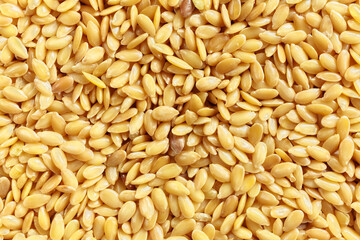 Close up picture of golden flaxseeds, selective focus.