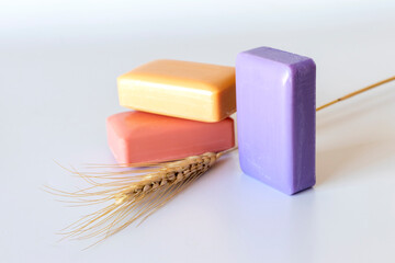 colored bath soaps, ear of wheat. close-up.