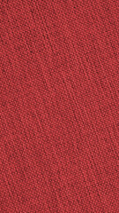 Dark red woven surface closeup. Textile texture similar to linen fabric. Sewing vertical background. Textured mobile phone wallpaper. Macro