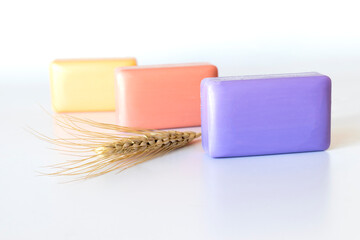 colored bath soaps, ear of wheat. close-up.