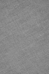 Gray woven surface closeup. Linen textile texture. Fabric sewing vertical background. Textured braided grey backdrop. Len black and white wallpaper. Macro