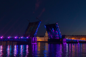 Fototapeta na wymiar The Palace Bridge with an illumination against a Saint Petersburg cityscape at summer night