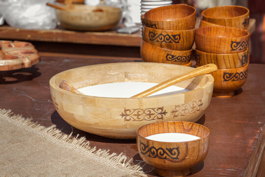 Traditional Asian wooden utensils with mare's milk koumiss or camel milk - shubat for sale in a street shop