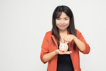 business woman hold piggy bank and putting coin with concrete wall for financial and saving money concept with concrete background and blank copy space.