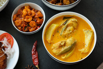 Kerala fish curry coconut milk gravy , cooking spicy Goan fish curry , Indian fish curry Bengali fish curry Christmas food Kolkata, India Sri Lanka. Lankan food.