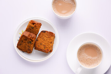 Woman serving homemade Christmas plum cake in white background India Kerala. Fruitcake of dried fruit, nuts, spices , rum New Year party, Easter, Christmas Eve. Indian Christmas celebration