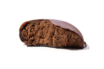 Broken piece of chocolate candy with cocoa filling mousse