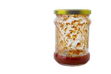 old jar with tomato juice and mold inside. isolated on white background 